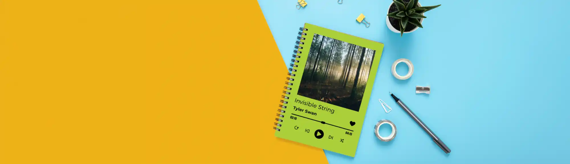 Green spiral notebook with a forest photo on the cover.