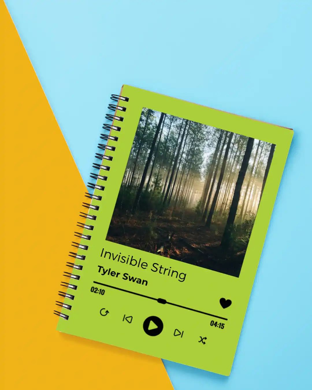Lime green spiral notebook with a Spotify player interface design showing ’Invisible String’ by Tyler Swan.